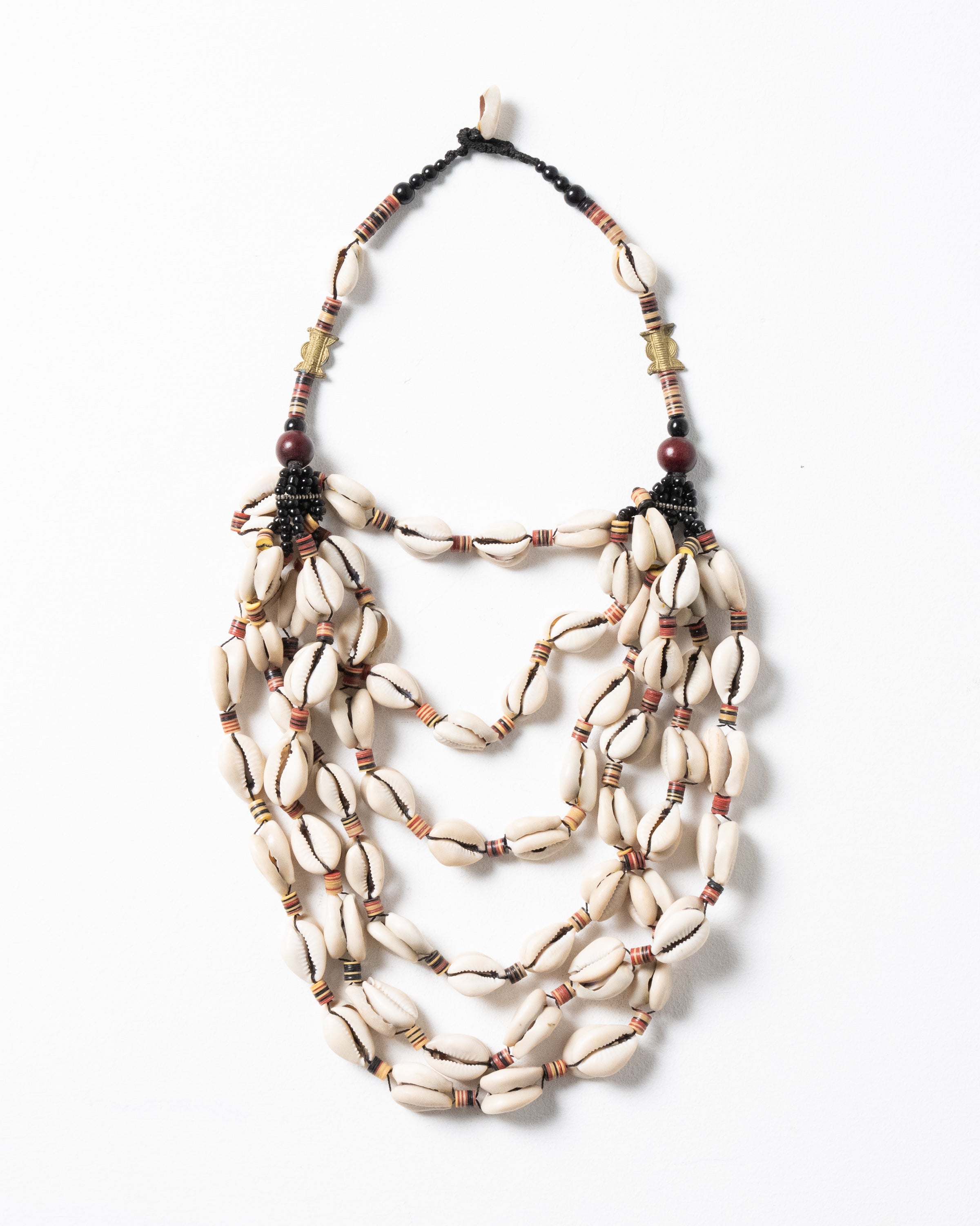 A six-strand Necklace featuring Traditional West African Cowrie Shells